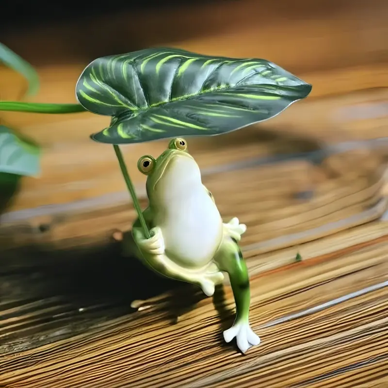 Sapo encantador segurando uma folha